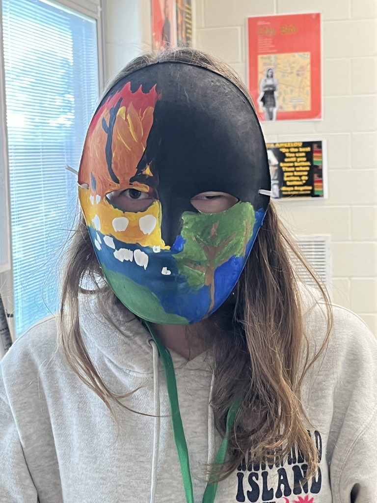 Image of student wearing mask they created for Oedipus play.